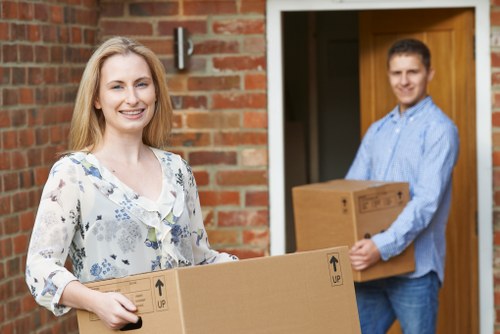 Removal team handling boxes and furniture in Gunnersbury