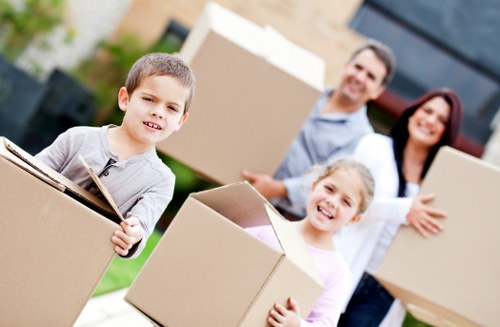Movers carrying furniture carefully through a residential property