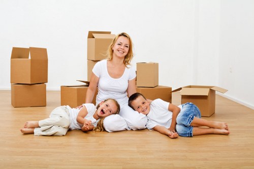 Packed household boxes and furniture ready for transport in Gunnersbury