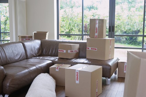 Professional movers handling furniture in a West London property