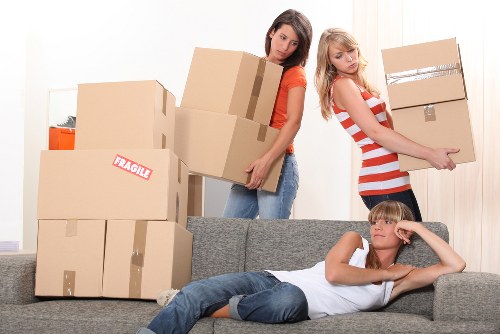 Removal team handling office furniture in a west London commercial move